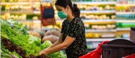 woman in the produce section at the grocery store