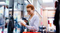 women looking at label in dairy section