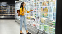 Woman shopping in refrigerated isle